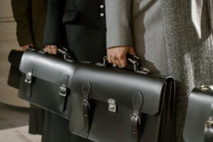 Two people holding briefcases, symbolizing professional family lawyers handling divorce law cases.